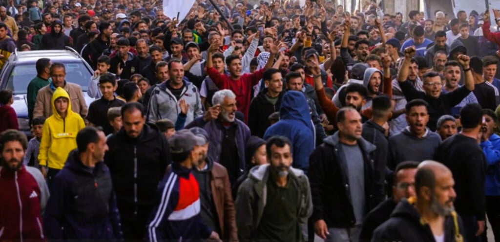 Large crowd of Palestinian protesters march through the streets of Beit Lahia, Gaza, during a rare anti-Hamas demonstration amid the ongoing war with Israel.
