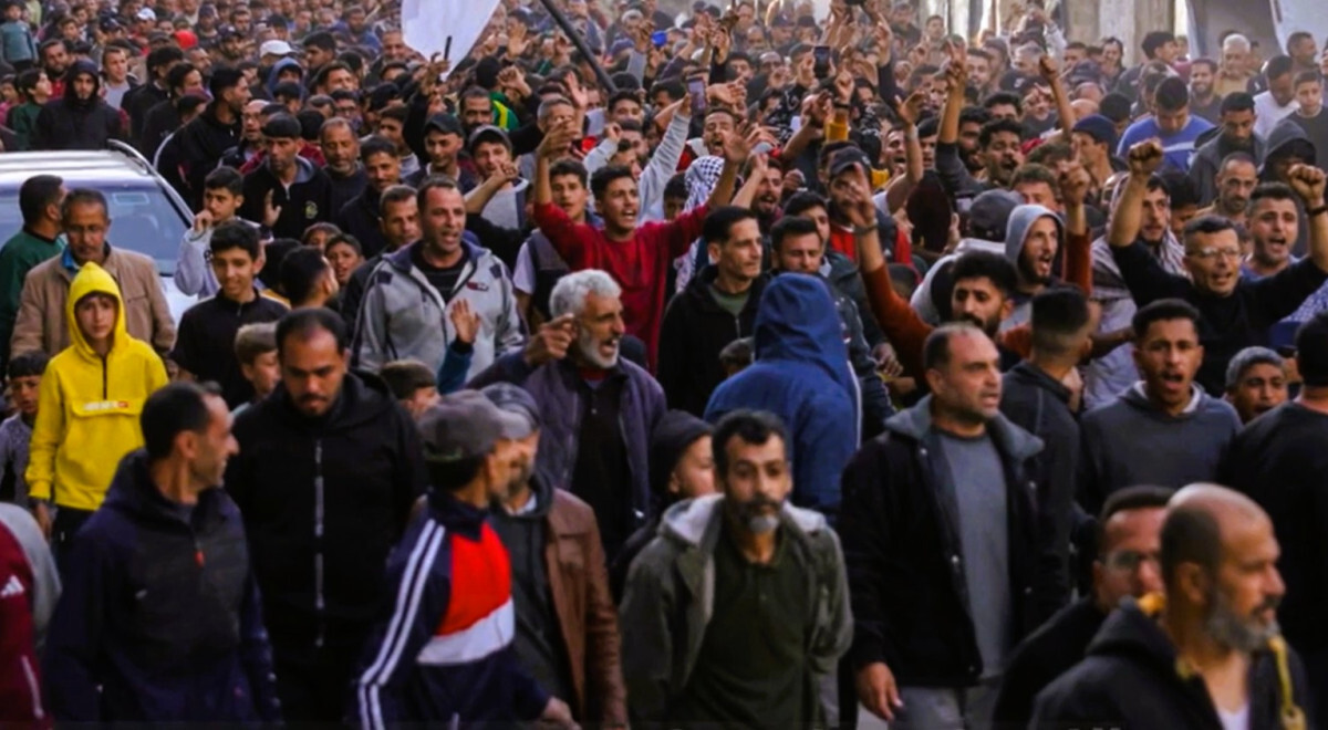 Large crowd of Palestinian protesters march through the streets of Beit Lahia, Gaza, during a rare anti-Hamas demonstration amid the ongoing war with Israel.