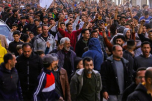Large crowd of Palestinian protesters march through the streets of Beit Lahia, Gaza, during a rare anti-Hamas demonstration amid the ongoing war with Israel.