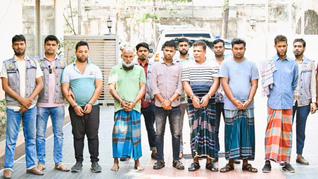 Group of arrested suspects in the Dhaka gold heist case, standing with law enforcement officers.