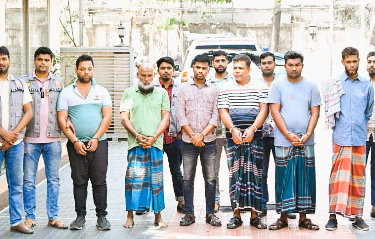 Group of arrested suspects in the Dhaka gold heist case, standing with law enforcement officers.