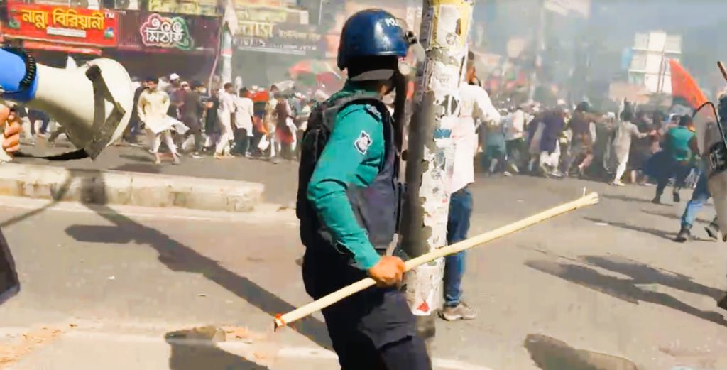 Protesters from the banned group Hizb ut-Tahrir march with banners in Dhaka as police intervene.