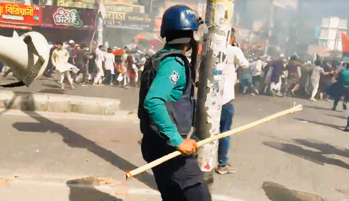 Protesters from the banned group Hizb ut-Tahrir march with banners in Dhaka as police intervene.