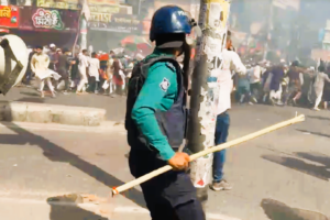 Protesters from the banned group Hizb ut-Tahrir march with banners in Dhaka as police intervene.