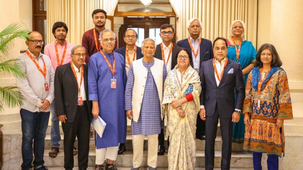 Members of the Media Reform Commission pose with Chief Adviser Professor Muhammad Yunus after submitting their report in Dhaka.