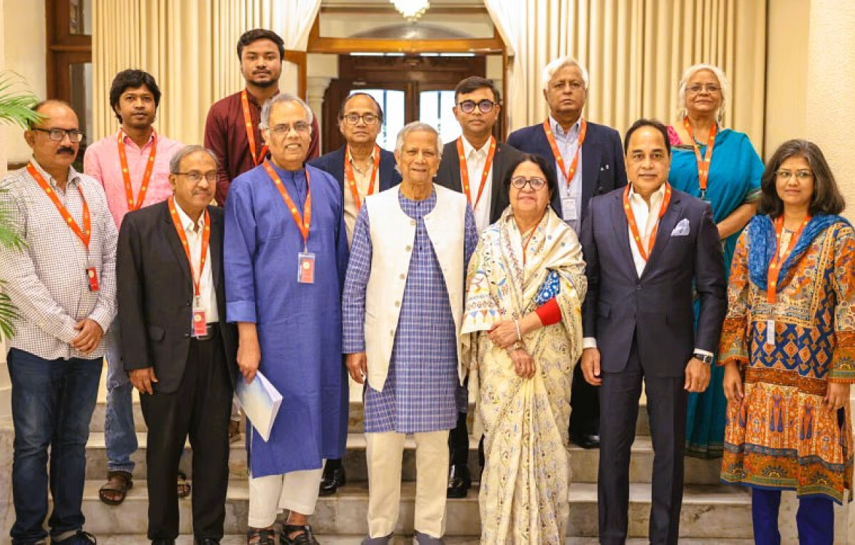 Members of the Media Reform Commission pose with Chief Adviser Professor Muhammad Yunus after submitting their report in Dhaka.