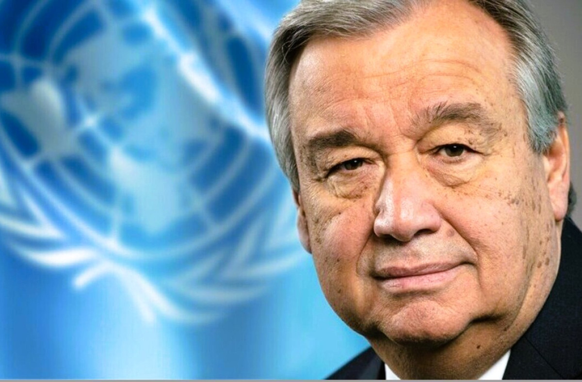 UN Secretary-General António Guterres with the United Nations flag in the background.