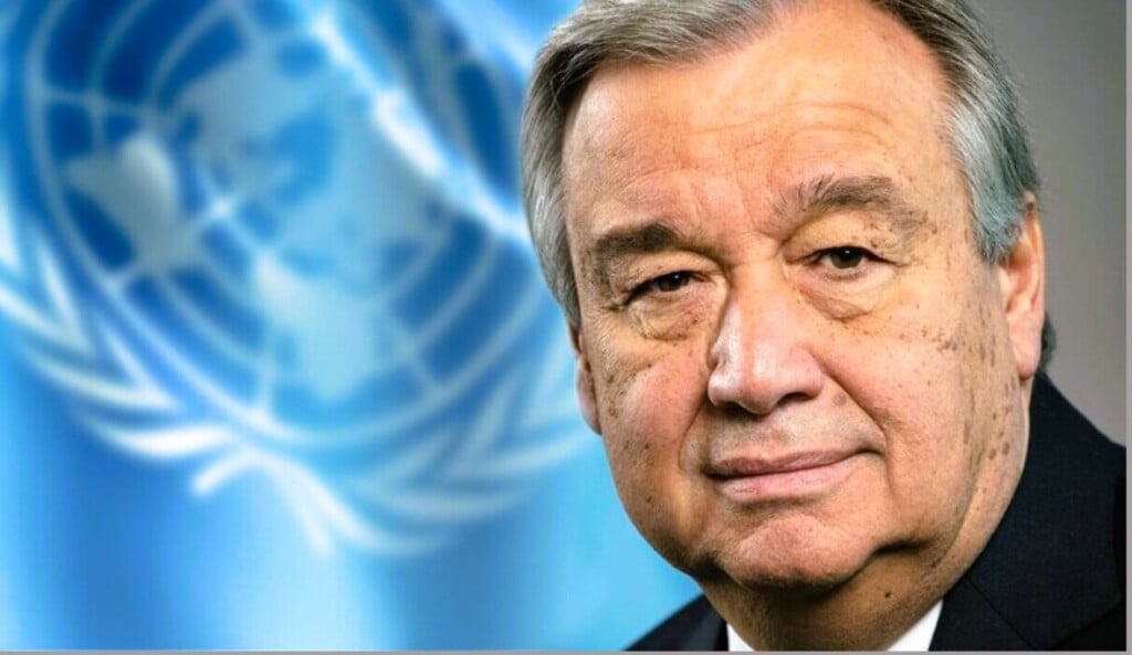 UN Secretary-General António Guterres with the United Nations flag in the background.