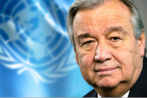 UN Secretary-General António Guterres with the United Nations flag in the background.
