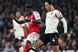 Arsenal holds onto top spot despite drawing with Liverpool.