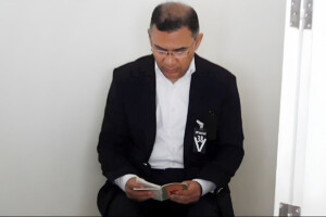 Tarek Rahman is reciting the Quran while seated beside his mother